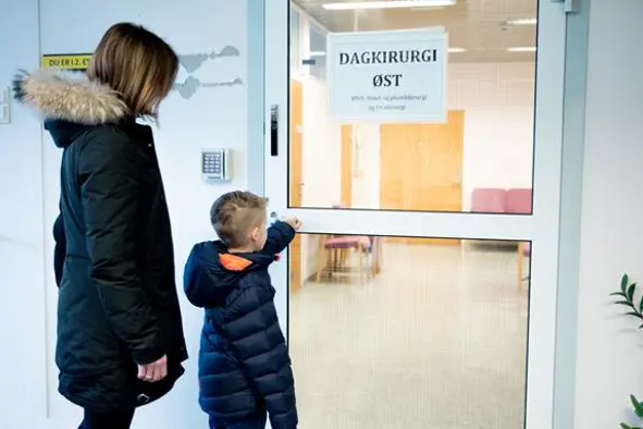 Elias og mamma står ved inngangsdøren. Foto.